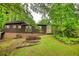 Home's backyard features a grassy lawn, bordered by mature trees creating a private outdoor space at 749 Dogwood Dr, Lawrenceville, GA 30046
