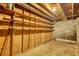 Unfinished basement features built-in shelving, open ceiling, concrete floor and block wall at 749 Dogwood Dr, Lawrenceville, GA 30046