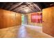 Spacious unfinished basement with paneled walls and red curtain at 749 Dogwood Dr, Lawrenceville, GA 30046