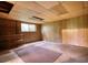Unfinished basement with paneled walls, window and shelving at 749 Dogwood Dr, Lawrenceville, GA 30046
