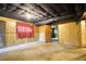 Unfinished basement featuring paneled walls, and open doorway at 749 Dogwood Dr, Lawrenceville, GA 30046