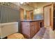 Bathroom with double vanity, floral wallpaper, and a classic design at 749 Dogwood Dr, Lawrenceville, GA 30046