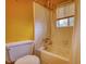 Bathroom with shower and tub combo, tiled walls, and window at 749 Dogwood Dr, Lawrenceville, GA 30046