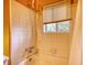 Outdated white tiled shower tub combo with white window blind at 749 Dogwood Dr, Lawrenceville, GA 30046