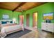 Bedroom with en-suite bathroom, ceiling fan, and hardwood floors at 749 Dogwood Dr, Lawrenceville, GA 30046