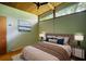 Cozy bedroom featuring a wood ceiling with fan, picture window, and neutral colors at 749 Dogwood Dr, Lawrenceville, GA 30046