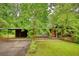 Beautiful home with a carport, surrounded by mature trees and lush greenery providing a serene and private environment at 749 Dogwood Dr, Lawrenceville, GA 30046
