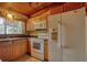 Kitchen featuring wood cabinets and a white refrigerator at 749 Dogwood Dr, Lawrenceville, GA 30046