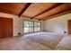 The bright living space features wood ceilings, carpet, and a large picture window at 749 Dogwood Dr, Lawrenceville, GA 30046