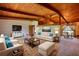 Staged living room boasting vaulted wood ceilings, tan carpeting, and cream colored furniture at 749 Dogwood Dr, Lawrenceville, GA 30046