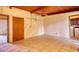 Large room with tile floor and wooden ceiling, adjacent to utility area at 749 Dogwood Dr, Lawrenceville, GA 30046