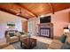 Bright living room featuring wooden ceiling, fireplace, and comfortable seating at 749 Dogwood Dr, Lawrenceville, GA 30046