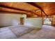 Spacious room with wood beam ceilings and a large window overlooking the yard at 749 Dogwood Dr, Lawrenceville, GA 30046