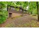 Back of the home features a private yard area, mature trees, and side entry at 749 Dogwood Dr, Lawrenceville, GA 30046