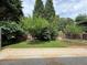 Lush backyard showcasing a green lawn, mature trees, and a wooden fence at 1245 Mulberry Mill Ln, Lawrenceville, GA 30043