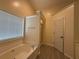 Bright bathroom featuring a soaking tub, shower, and neutral walls at 1245 Mulberry Mill Ln, Lawrenceville, GA 30043
