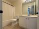 Standard bathroom with tile flooring, toilet, sink, and tub at 1245 Mulberry Mill Ln, Lawrenceville, GA 30043