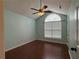 Stylish bedroom with hardwood floors, ceiling fan, and arched window at 1245 Mulberry Mill Ln, Lawrenceville, GA 30043
