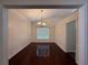Formal dining room with hardwood floors, elegant chandelier, and wainscoting detail at 1245 Mulberry Mill Ln, Lawrenceville, GA 30043