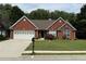 Charming brick home with a well-manicured lawn, two-car garage, and inviting curb appeal at 1245 Mulberry Mill Ln, Lawrenceville, GA 30043