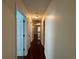 Well-lit hallway with hardwood floors connecting multiple rooms in the home's interior at 1245 Mulberry Mill Ln, Lawrenceville, GA 30043
