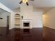 Cozy living room featuring a fireplace with built-in shelves and hardwood floors at 1245 Mulberry Mill Ln, Lawrenceville, GA 30043