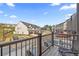 View from balcony overlooking neighborhood with modern townhomes and well-maintained landscaping at 125 Climbing Ivy Cir, Fayetteville, GA 30214