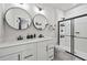 Sleek bathroom featuring dual sinks, modern fixtures, and walk-in shower with glass doors at 125 Climbing Ivy Cir, Fayetteville, GA 30214