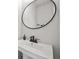 Stylish bathroom featuring a modern sink with black faucet and round mirror at 125 Climbing Ivy Cir, Fayetteville, GA 30214