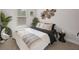 Bright bedroom with a large bed, cozy decor, and a decorative woven wall hanging at 125 Climbing Ivy Cir, Fayetteville, GA 30214