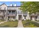Charming townhome with a mix of white brick and gray siding, a well manicured lawn, and a private balcony at 125 Climbing Ivy Cir, Fayetteville, GA 30214
