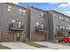Rear exterior view of modern townhomes with attached garages and private balconies at 125 Climbing Ivy Cir, Fayetteville, GA 30214