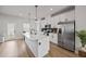 Modern kitchen featuring white cabinets, an island, and stainless steel appliances at 125 Climbing Ivy Cir, Fayetteville, GA 30214