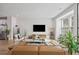 Open-concept living room with hardwood floors, modern furniture, and lots of natural light at 125 Climbing Ivy Cir, Fayetteville, GA 30214