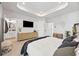 Spacious primary bedroom featuring a tray ceiling, ensuite bathroom, and ample natural light at 125 Climbing Ivy Cir, Fayetteville, GA 30214