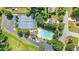 Aerial view of community pool, tennis courts, and clubhouse surrounded by lush greenery at 1387 Sw Haynes Meadow Trl, Grayson, GA 30017