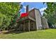 A lovely backyard with the home's deck, green lawn, and surrounding trees offers an outdoor experience at 1387 Sw Haynes Meadow Trl, Grayson, GA 30017