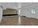 Bright basement showcasing neutral tile, a built-in shelf and a door to the outside at 1387 Sw Haynes Meadow Trl, Grayson, GA 30017