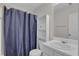 Clean bathroom with vanity and shower with blue curtain at 1387 Sw Haynes Meadow Trl, Grayson, GA 30017
