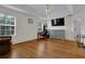 Bright bedroom with wood floors, desk area, and ceiling fan at 1387 Sw Haynes Meadow Trl, Grayson, GA 30017