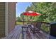 An angle view of the deck showing seating, a grill, and an umbrella provides a space for cooking and entertaining at 1387 Sw Haynes Meadow Trl, Grayson, GA 30017