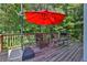 This beautiful deck includes patio furniture, a grill, and a bright red umbrella for shade and relaxation at 1387 Sw Haynes Meadow Trl, Grayson, GA 30017