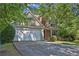 Charming two-story home with a two-car garage and beautiful landscaping at 1387 Sw Haynes Meadow Trl, Grayson, GA 30017