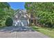 Charming two-story home featuring a two-car garage and a manicured front lawn with lush greenery at 1387 Sw Haynes Meadow Trl, Grayson, GA 30017