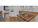 Open kitchen view with a sink in a repurposed, rustic wooden countertop, hardwood floors, and stainless dishwasher at 1387 Sw Haynes Meadow Trl, Grayson, GA 30017