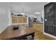 Eat-in kitchen with stainless steel appliances, custom storage, and access to an adjoining dining space at 1387 Sw Haynes Meadow Trl, Grayson, GA 30017