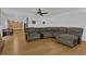 Open-concept living room with hardwood flooring, a large sectional sofa, and access to the kitchen at 1387 Sw Haynes Meadow Trl, Grayson, GA 30017