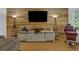 Cozy living room with a reclaimed wood accent wall, entertainment center, and comfortable seating at 1387 Sw Haynes Meadow Trl, Grayson, GA 30017