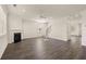 Bright living room with dark wood floors, fireplace, ceiling fan, and staircase at 301 Sandy Oak Dr, Loganville, GA 30052