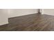 Spacious open living room with dark wood-look flooring and white walls at 301 Sandy Oak Dr, Loganville, GA 30052